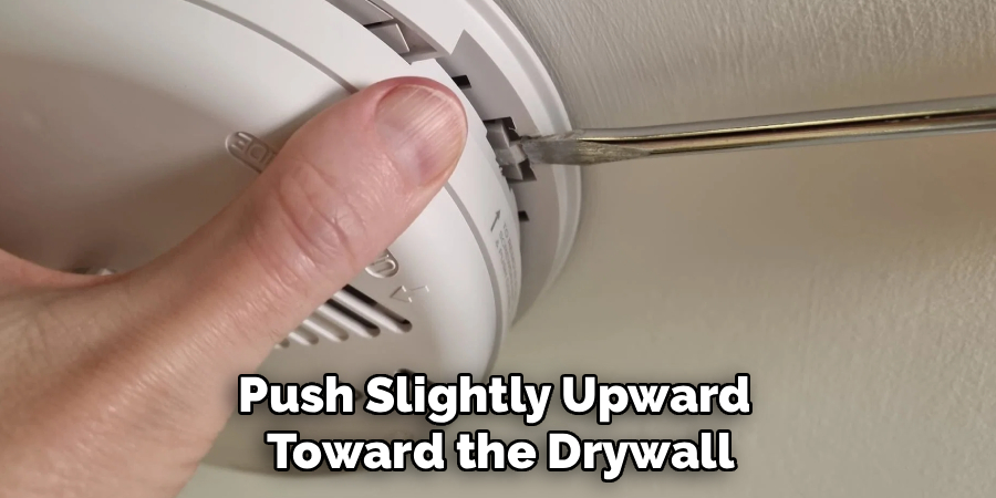 Push Slightly Upward 
Toward the Drywall